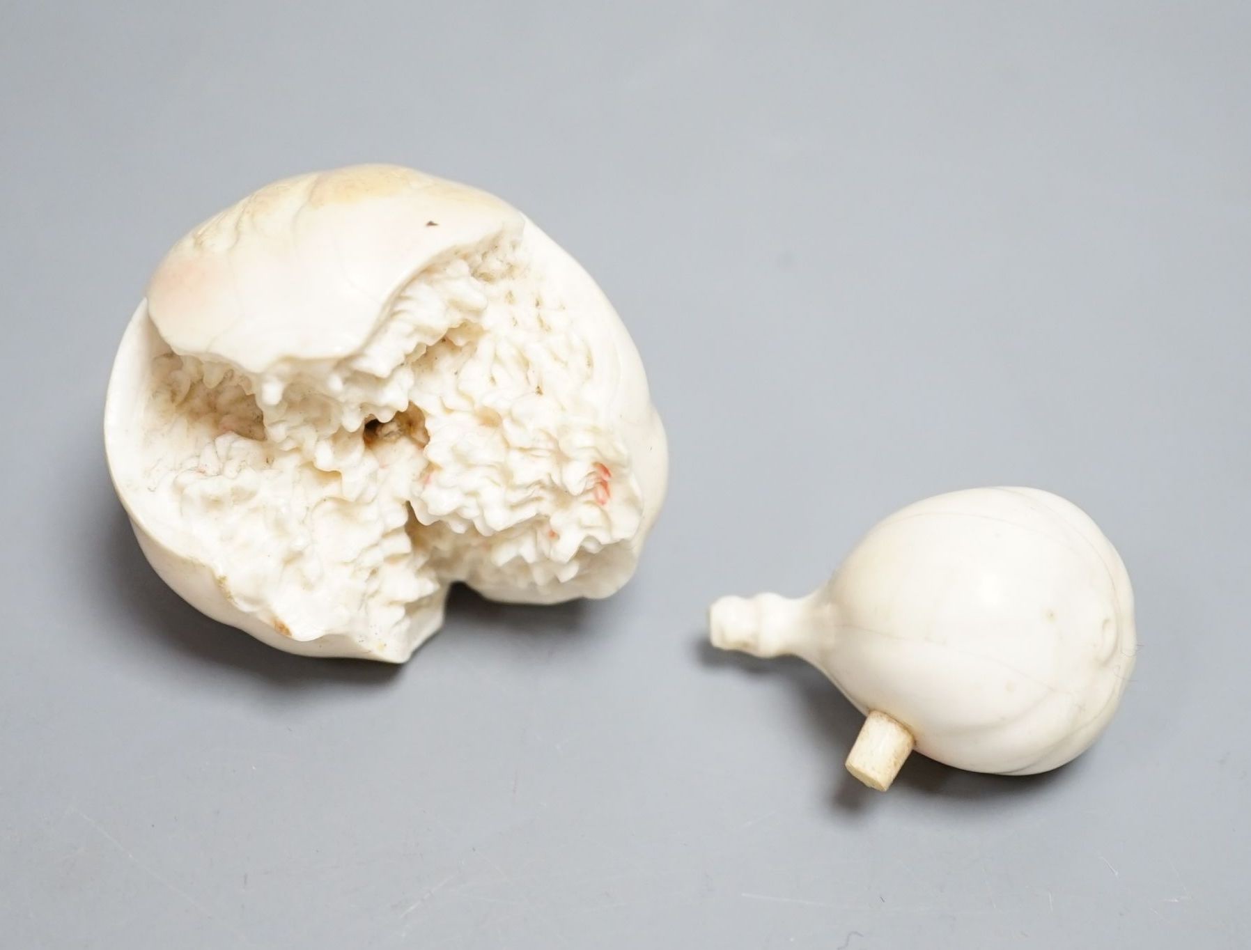 A Japanese ivory model of a partially peeled banana and an ivory model of figs, early 20th century (2) 15.5cm